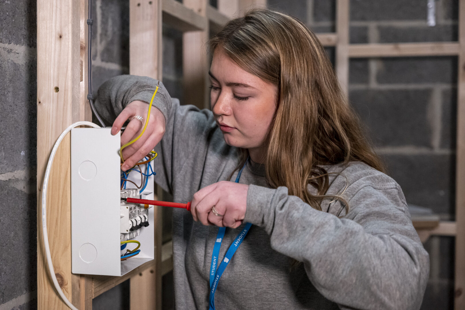 an electrical installation student using equipment to check wiring
