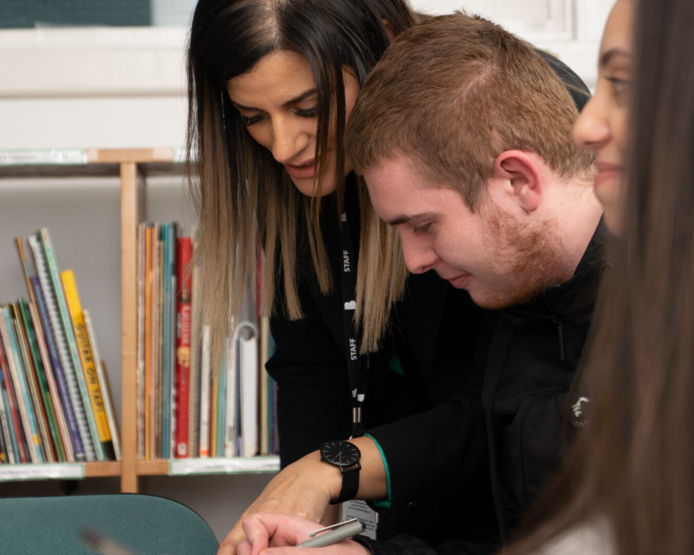 member of staff discussing work with a student