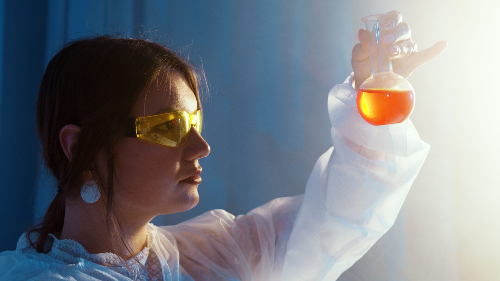 science student looking into a test tube full of liquid