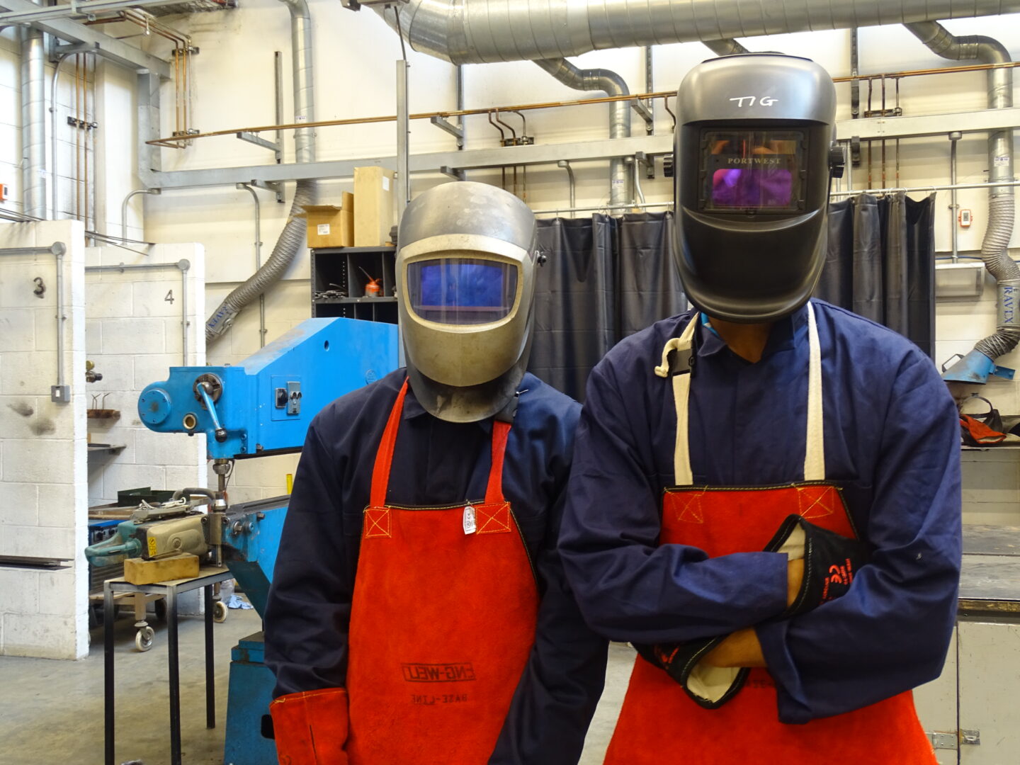 welding students stood in a welding workshop wearing safety equipment