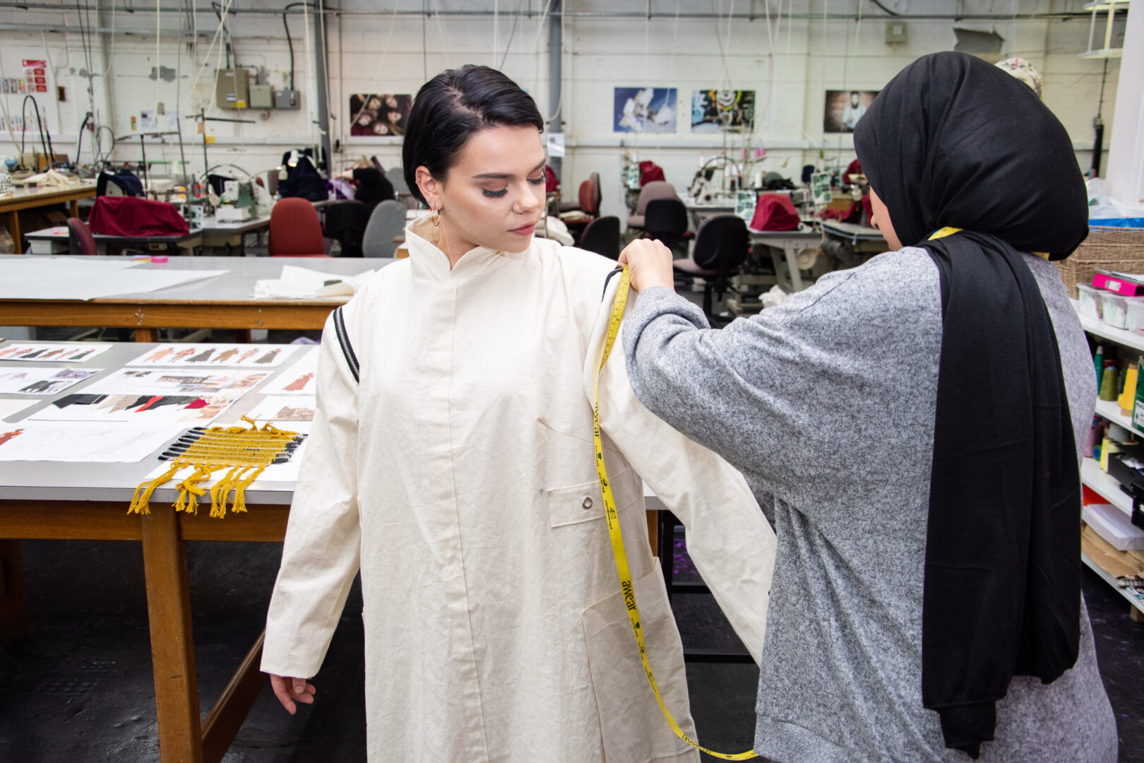fashion student fitting sleeves onto a piece of clothing