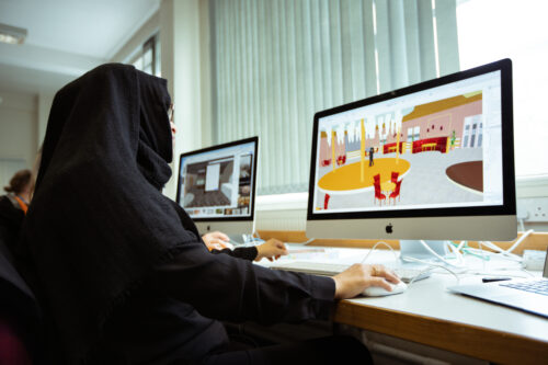 art and design student designing a room on a mac computer