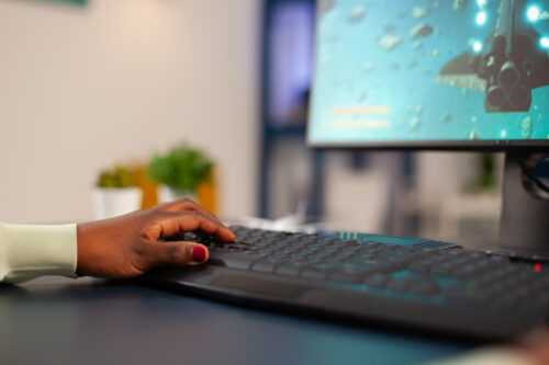 professional esports competitive gamer using game keyboard
