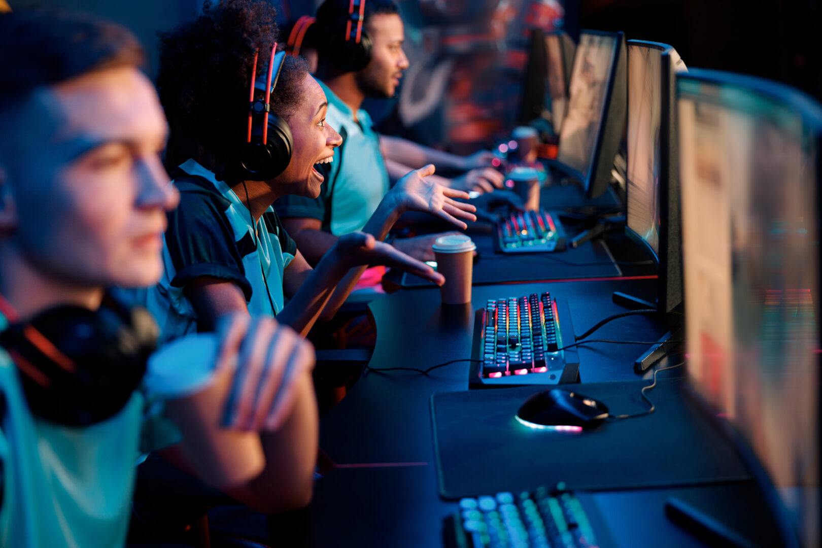 Esports team playing game on computers in gaming club