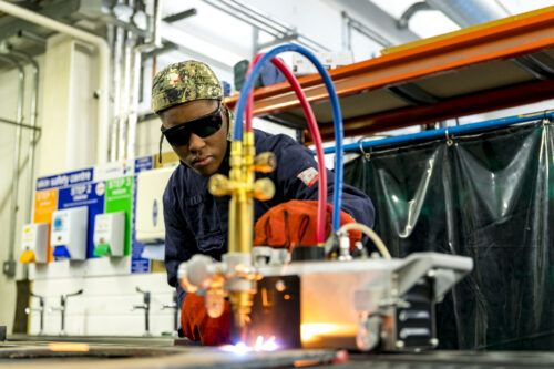 welding student welding as sparks fly