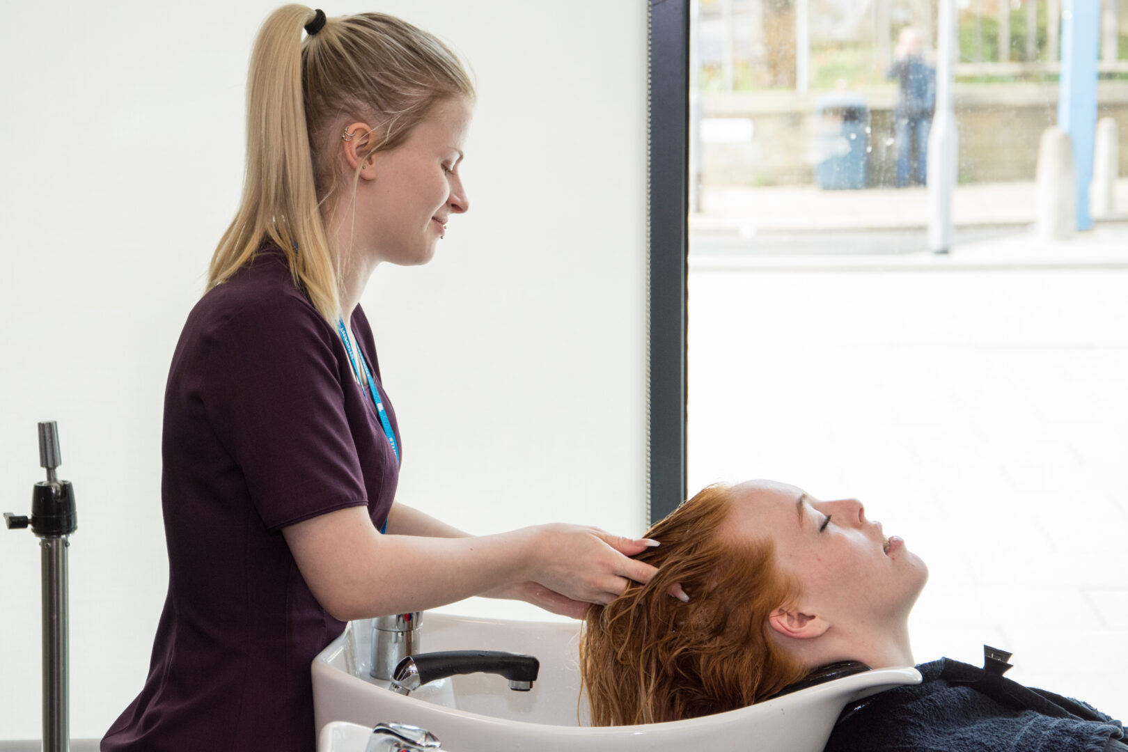 hairdressing student washing the hair of a model