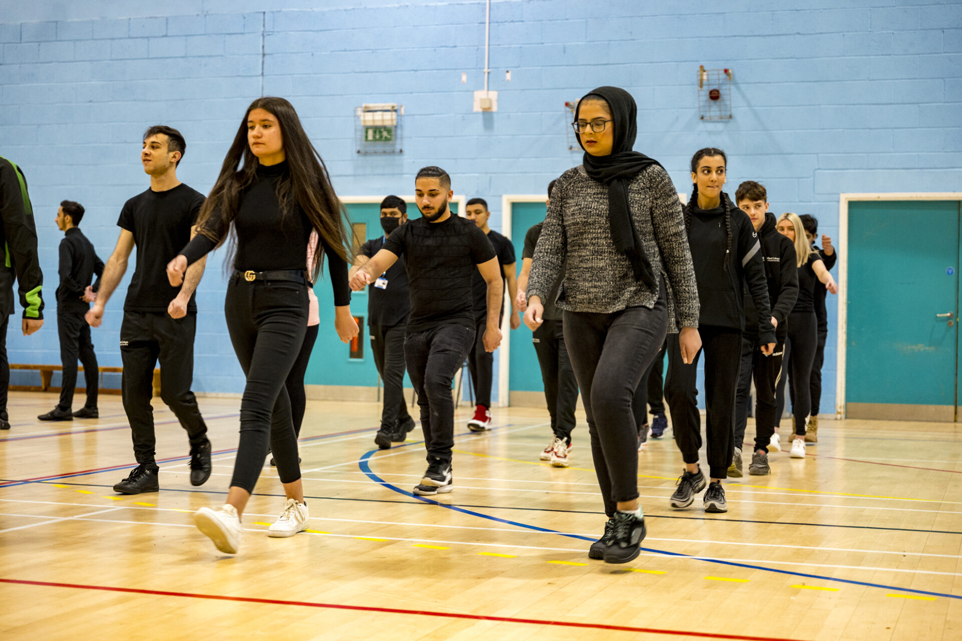 Uniformed Public Services students march in the sports hall