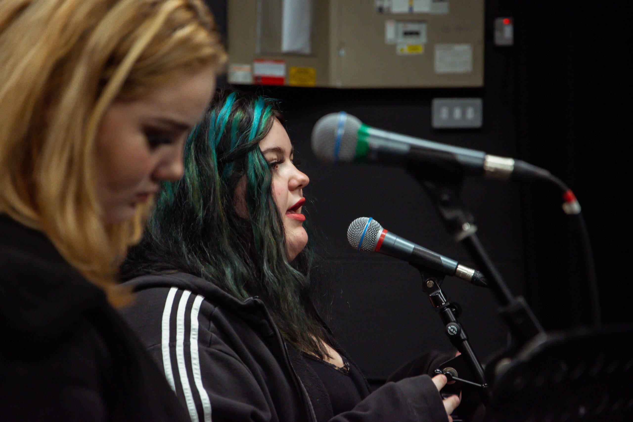 music students singing into a microphone