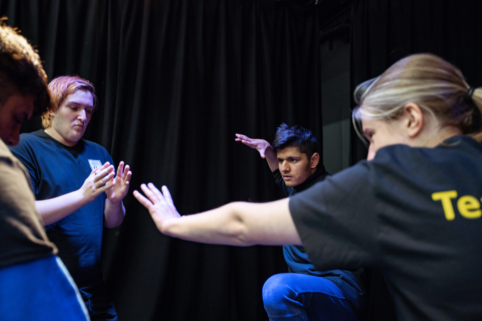 performing arts students stretching and warming up before a performance