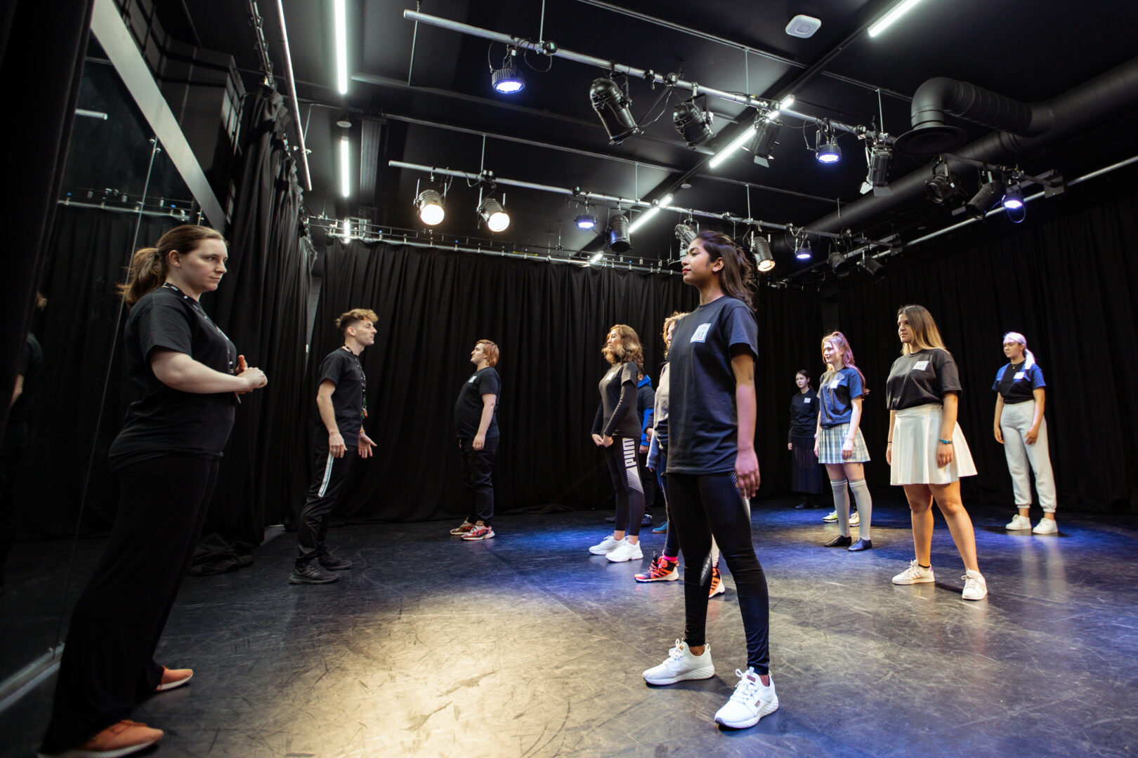 a group of performing arts students stood in a class