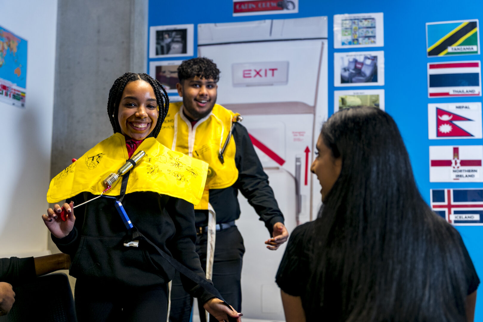 travel and tourism students practising wearing inflatable life jackets