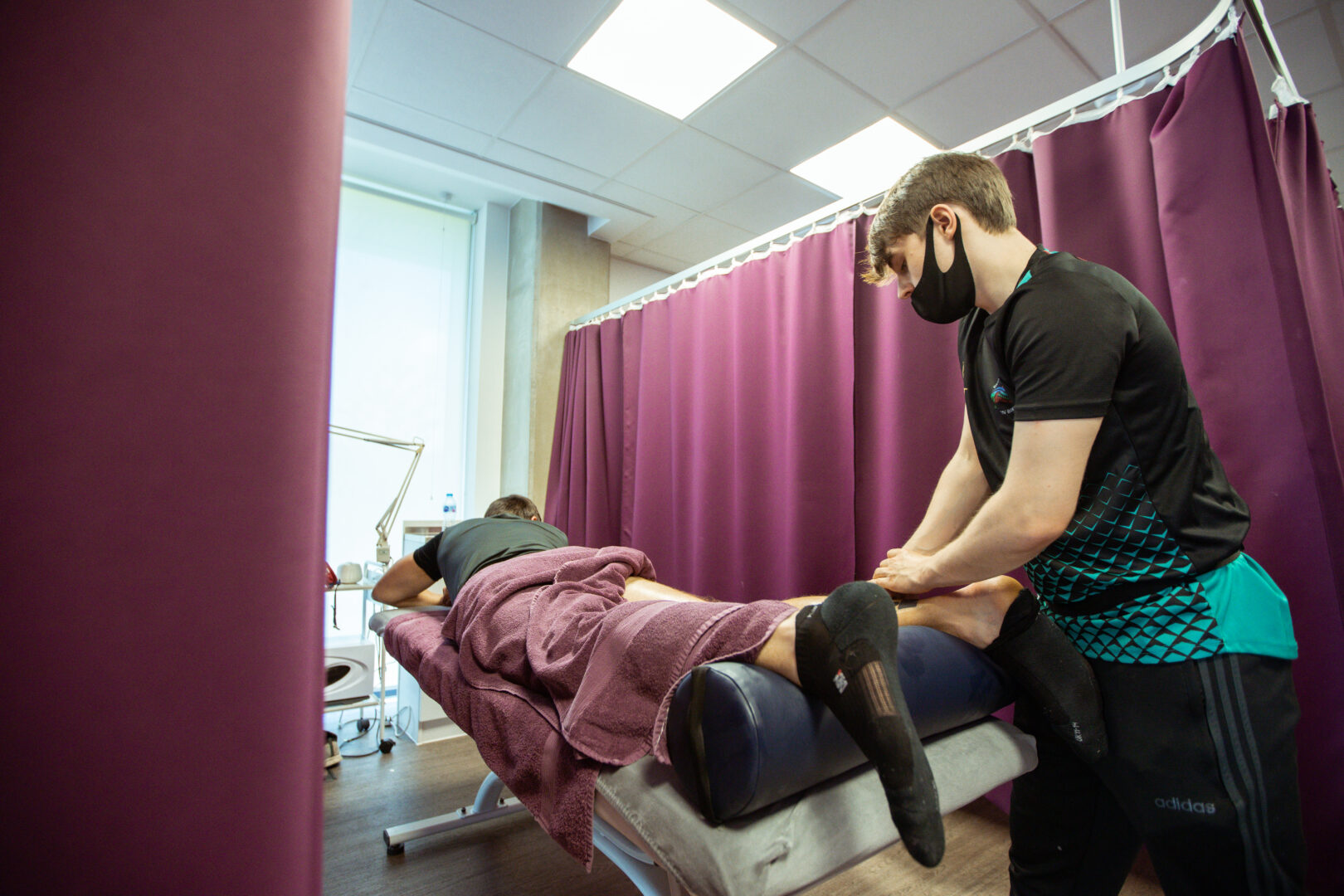 sports massage therapy student practising techniques