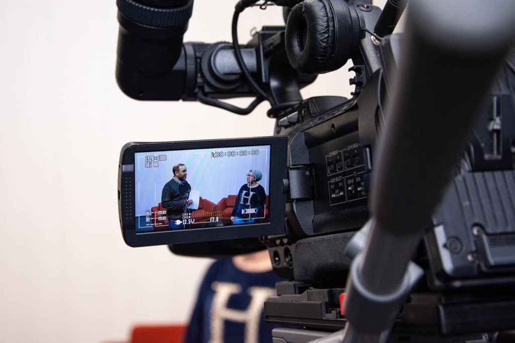 television camera filming a teacher and student