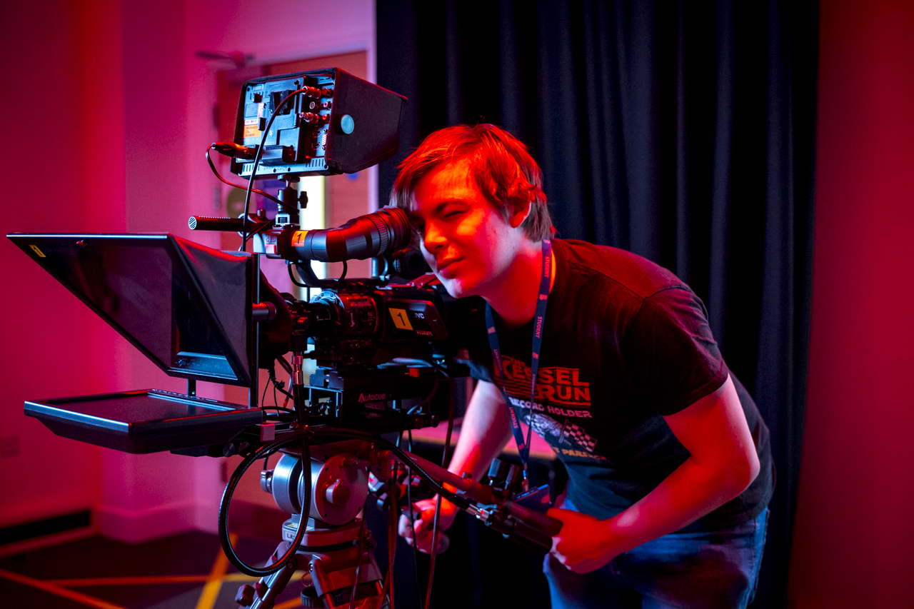 media and film student operating a large television filming camera