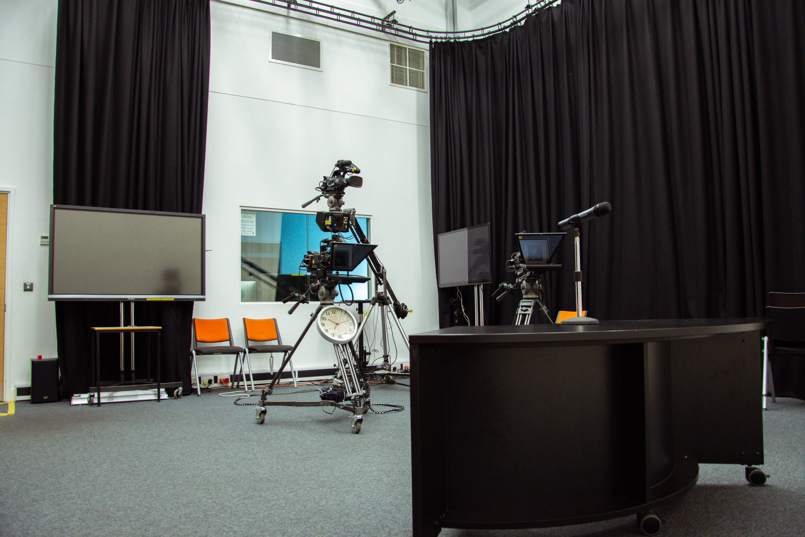 film and media facilities including television camera equipment, a microphone and television screens