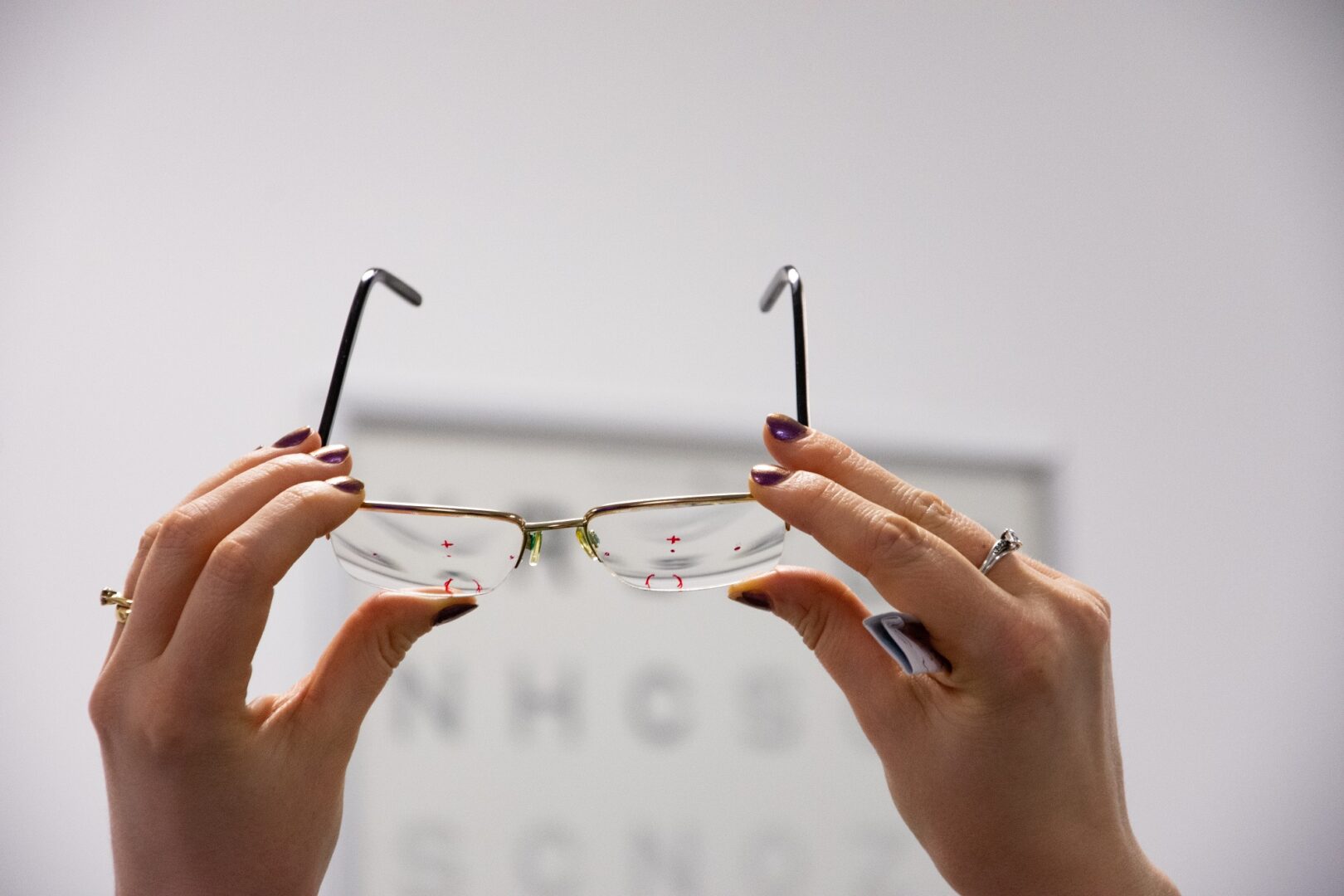 students holding a pair of prescription glasses