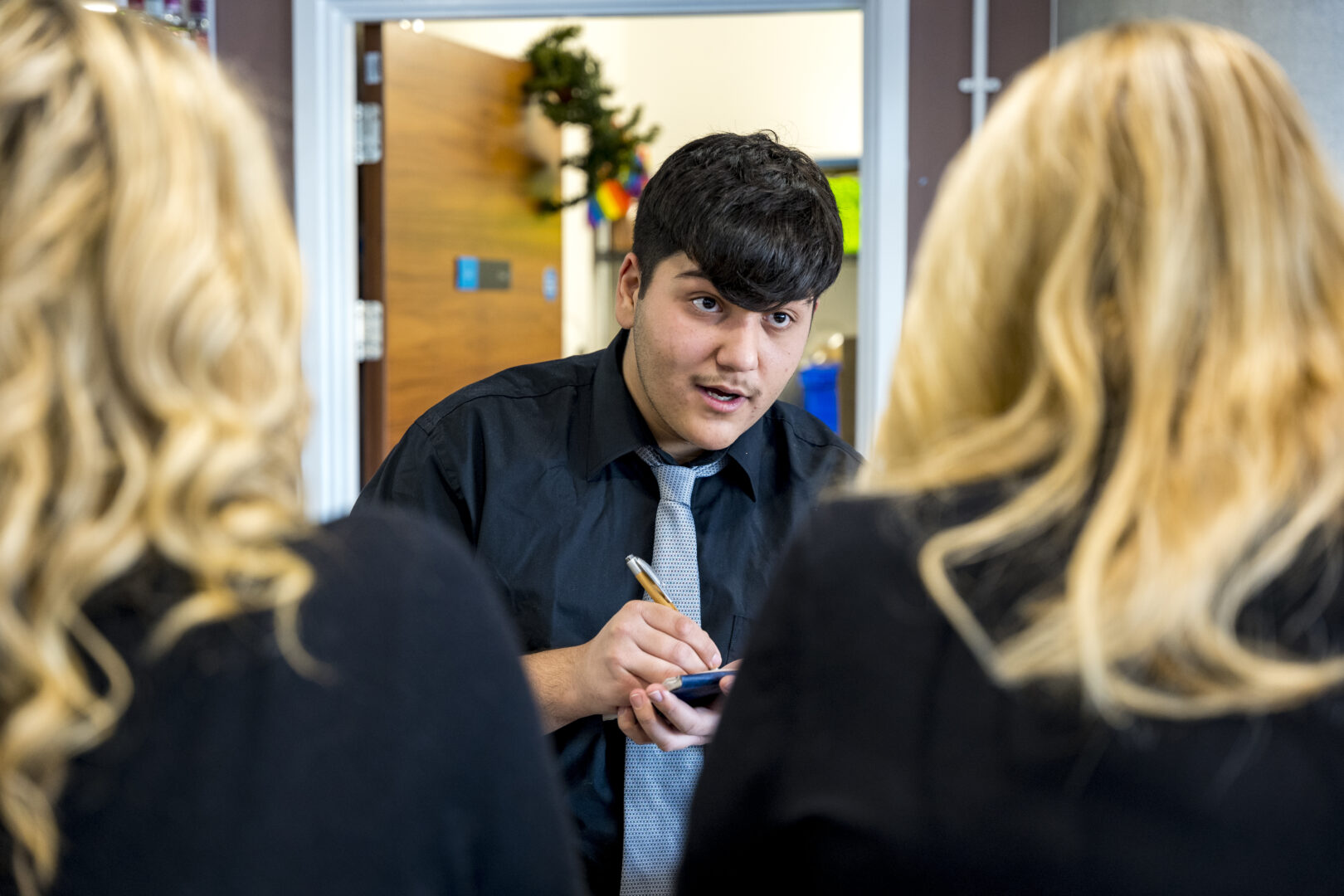 catering and hospitality student taking the order of two female guests at the grove restaurant
