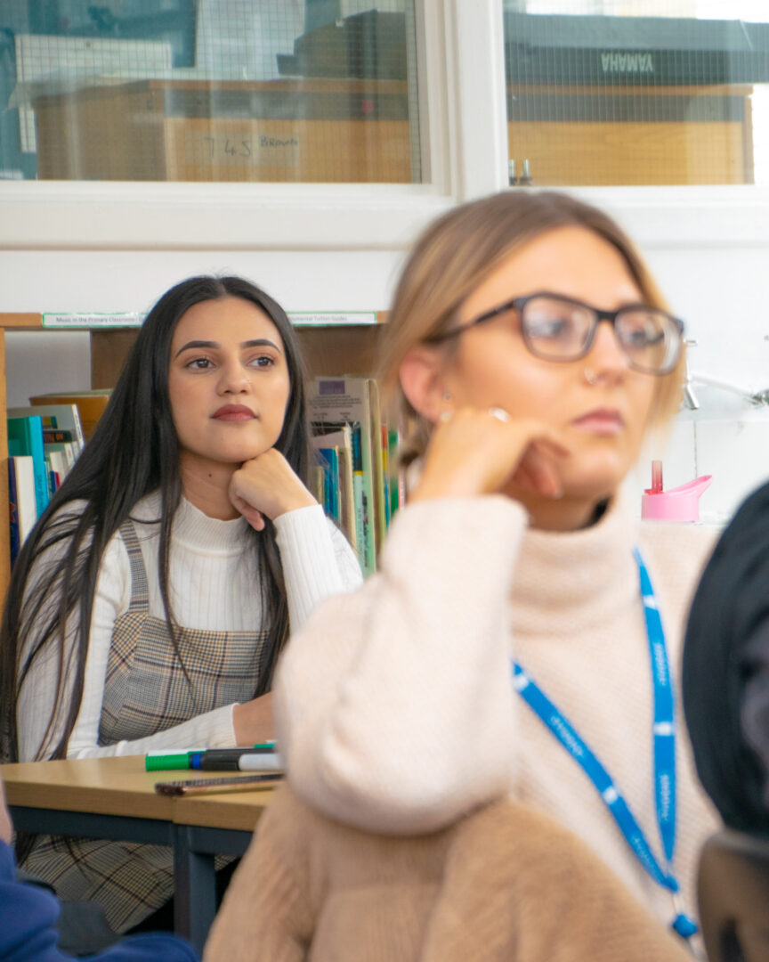 students sat in a classroom listening to the teacher