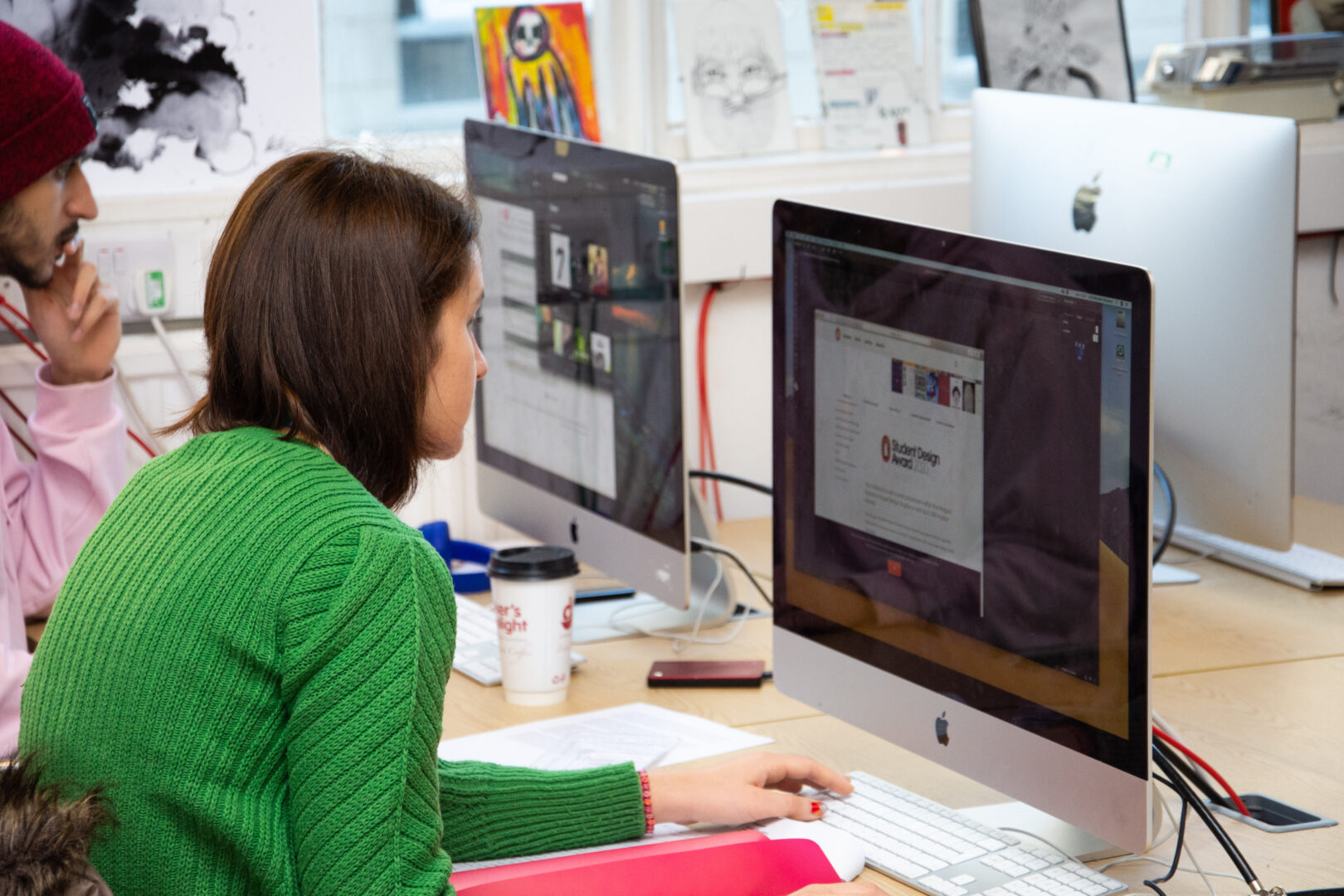 student sat at a mac screen