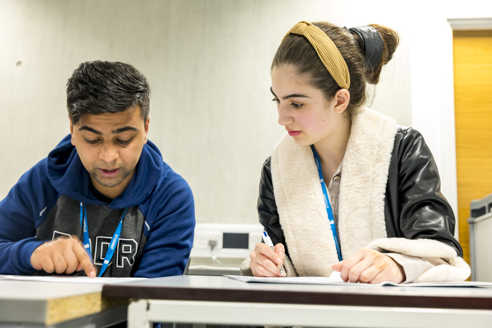 two students sat at a desk