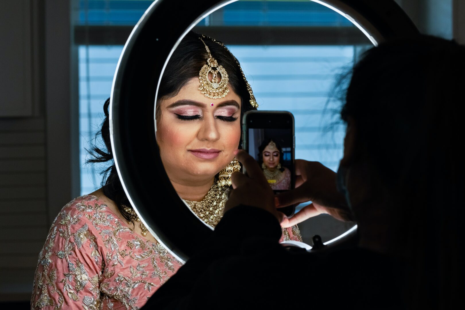 image of a model with a face of asian bridal make up getting a photograph taken