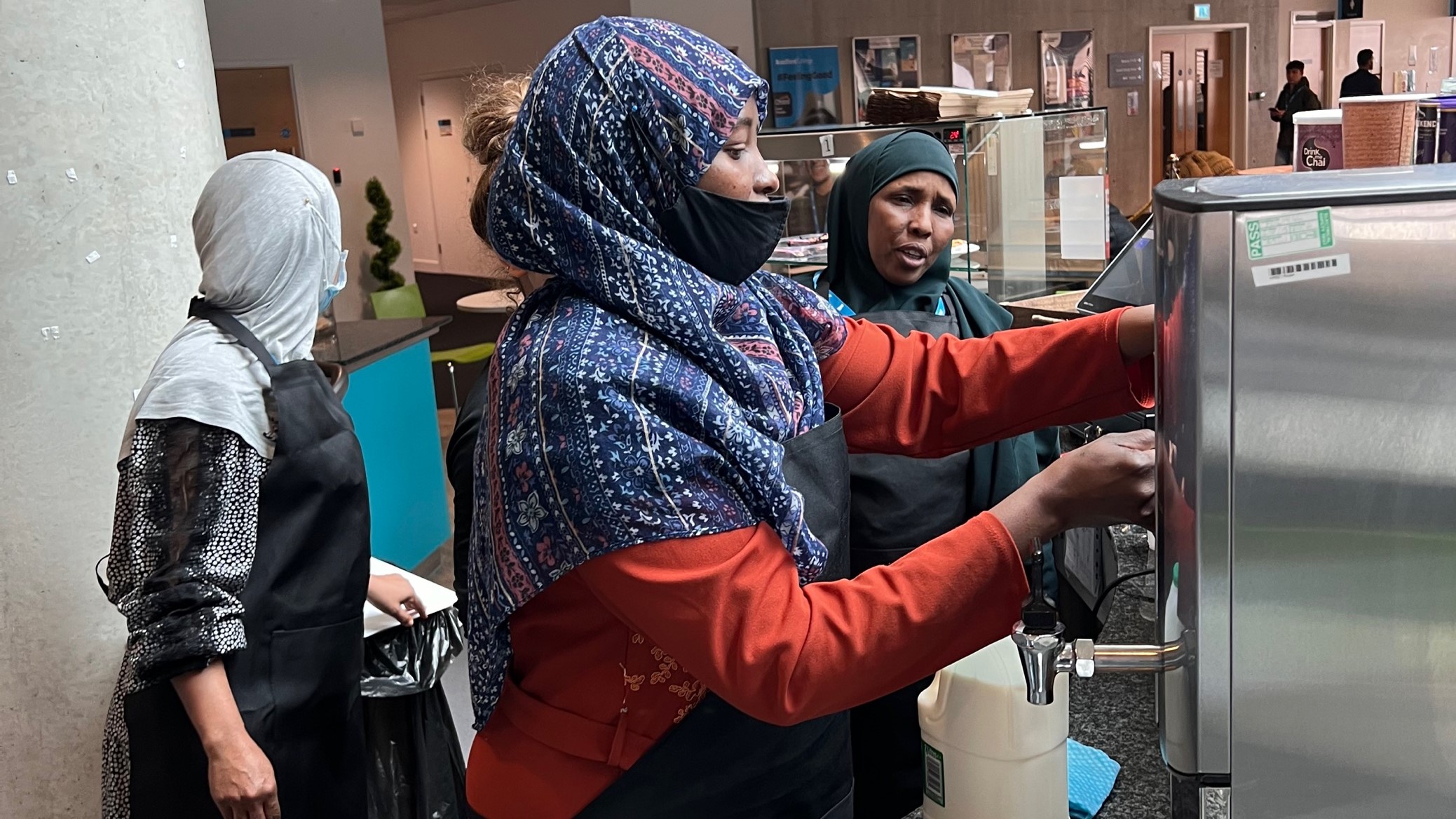 students at a coffee machine at the Jo Cox Cafe