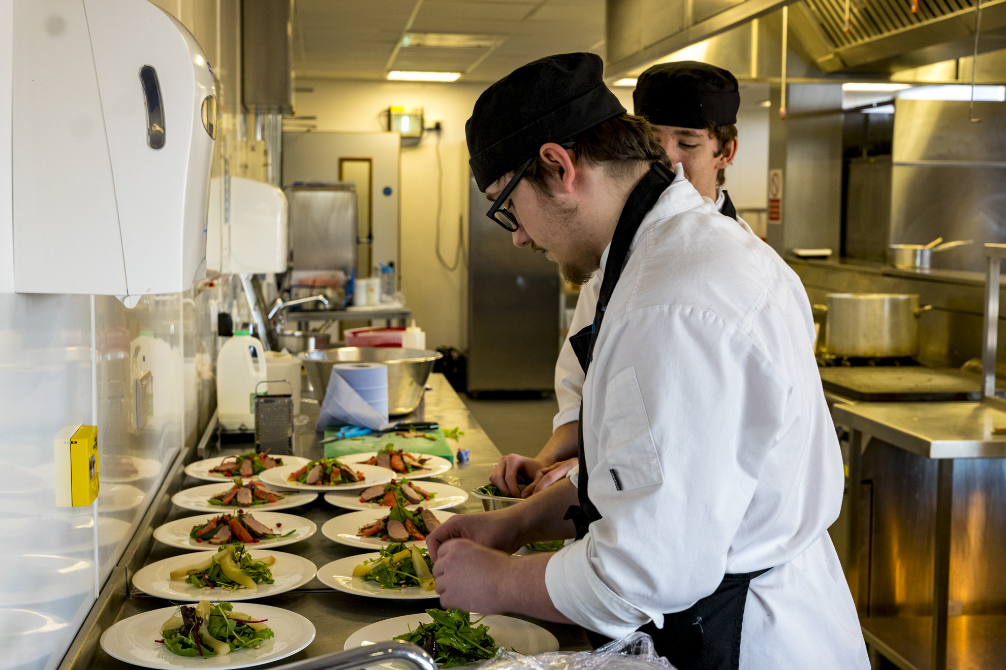 a catering student preparing meals in the college kitchen