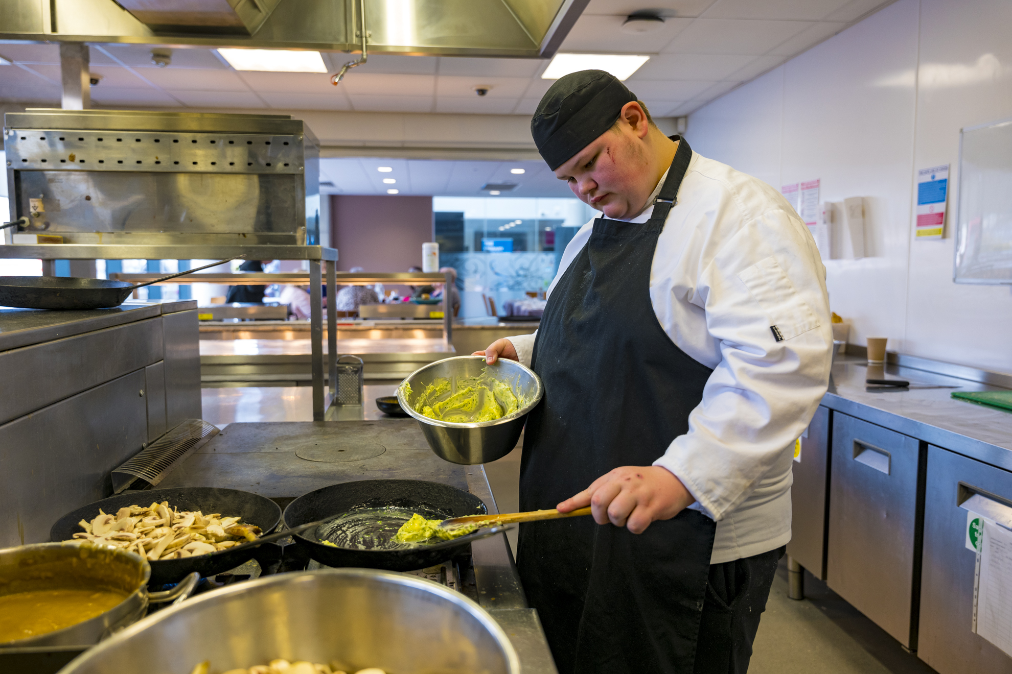 a catering student preparing meals in the college kitchen