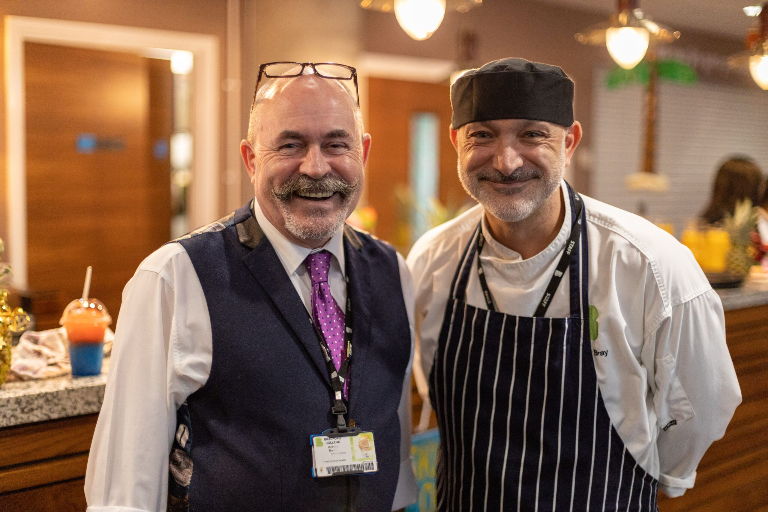 two catering tutors stood next to each other smiling