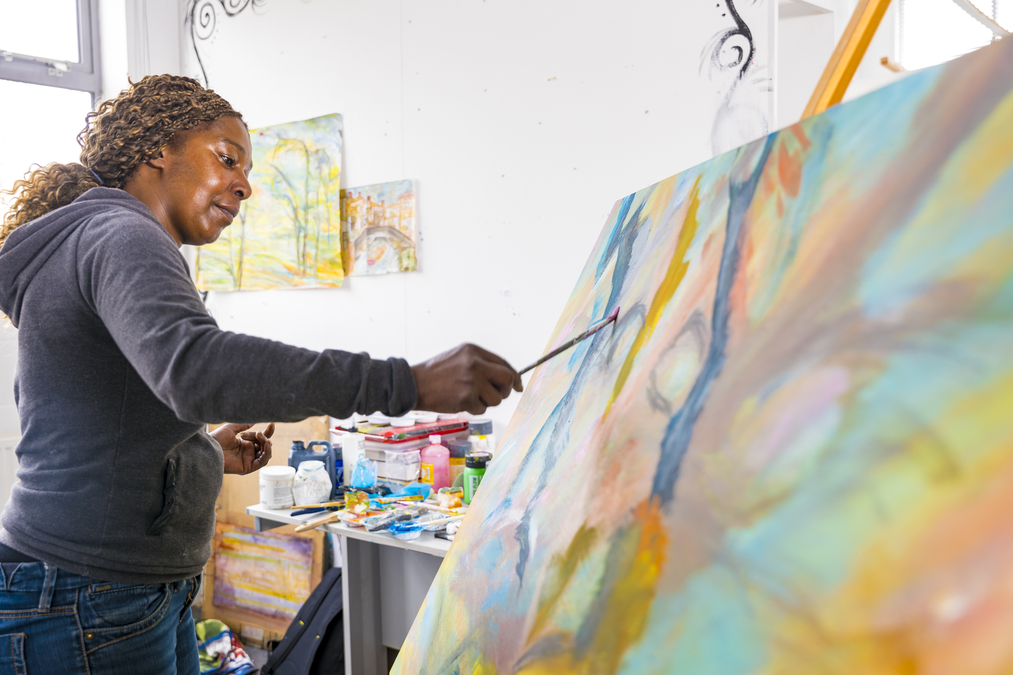 art student painting on a large canvas