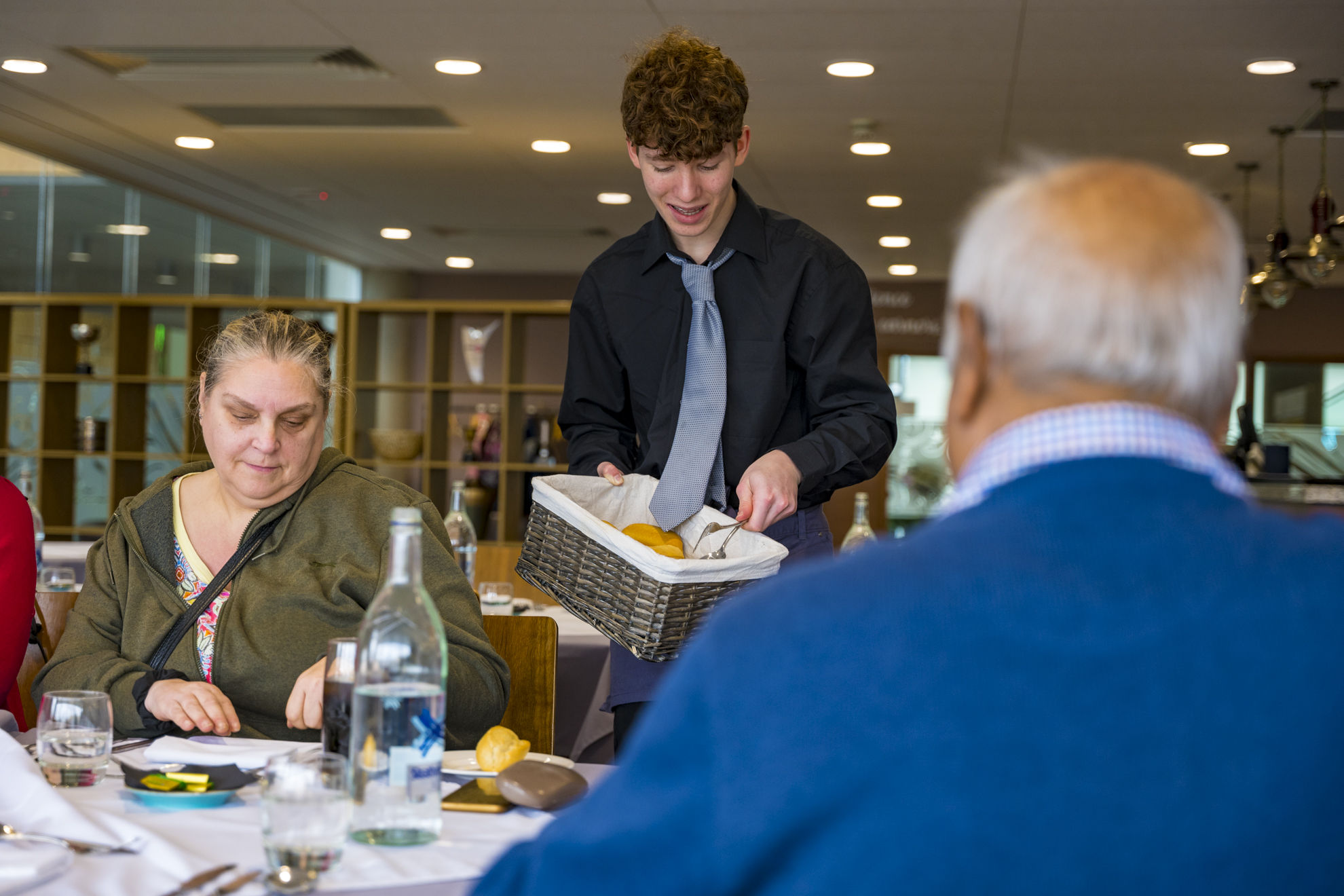 a student waiter working at the grove restaurant