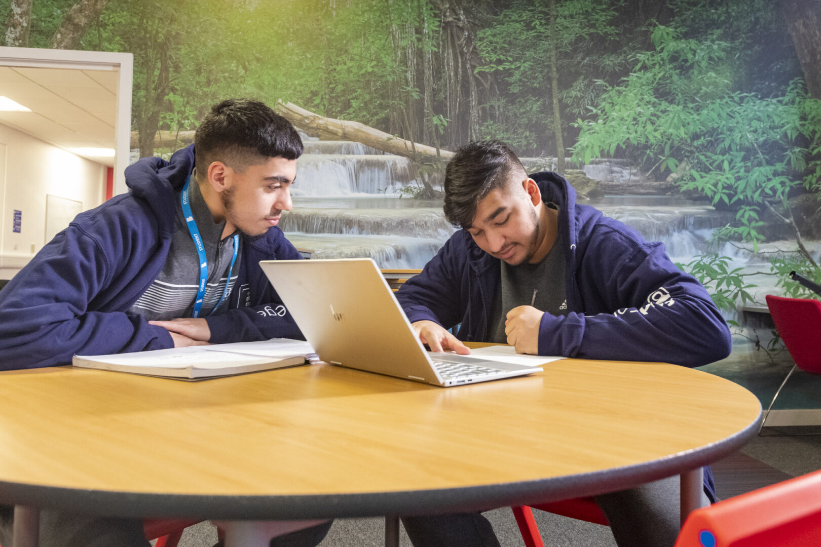 two sixth form students sat at a desk