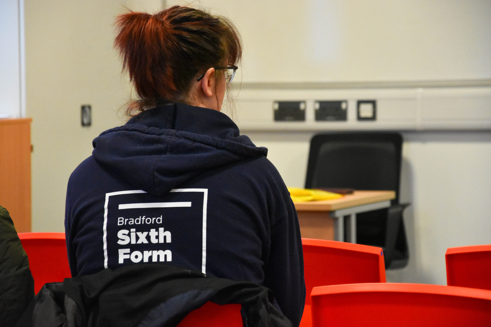 a bradford sixth form student listening to a motivational presentation