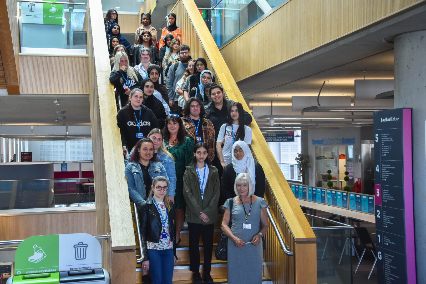 80 Fast Track to T Level Health students lined up on a staircase after completing work experience in the nhs