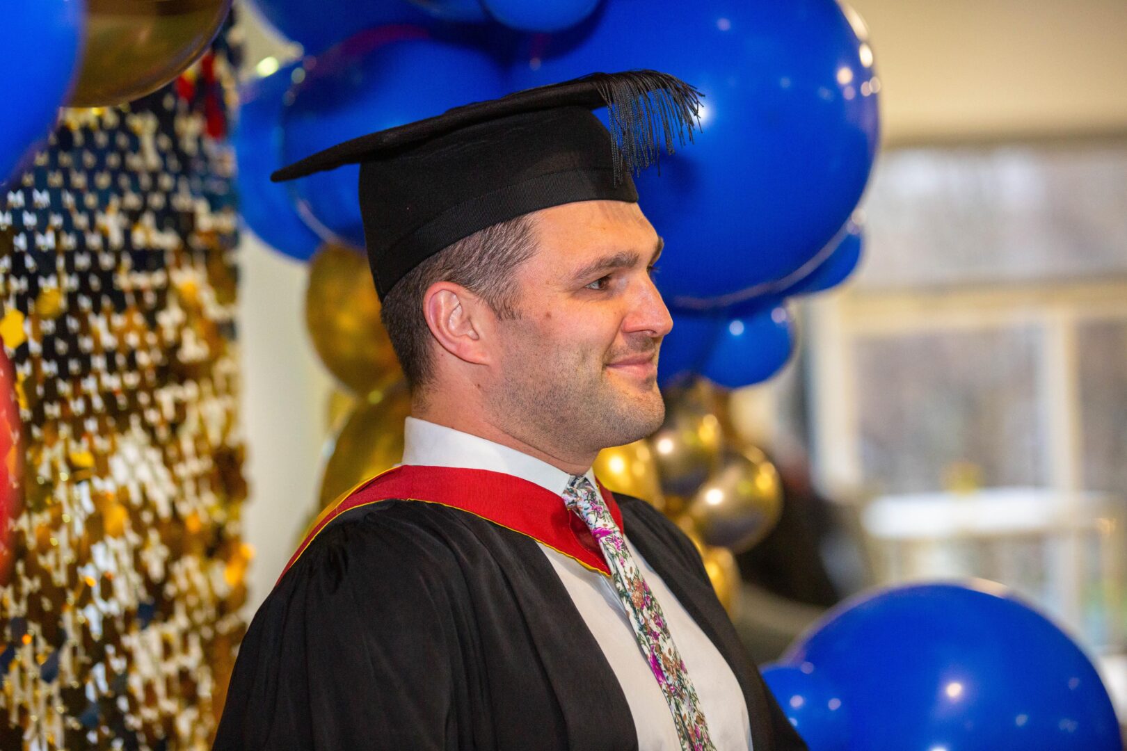 a smiling graduate getting their photo taken