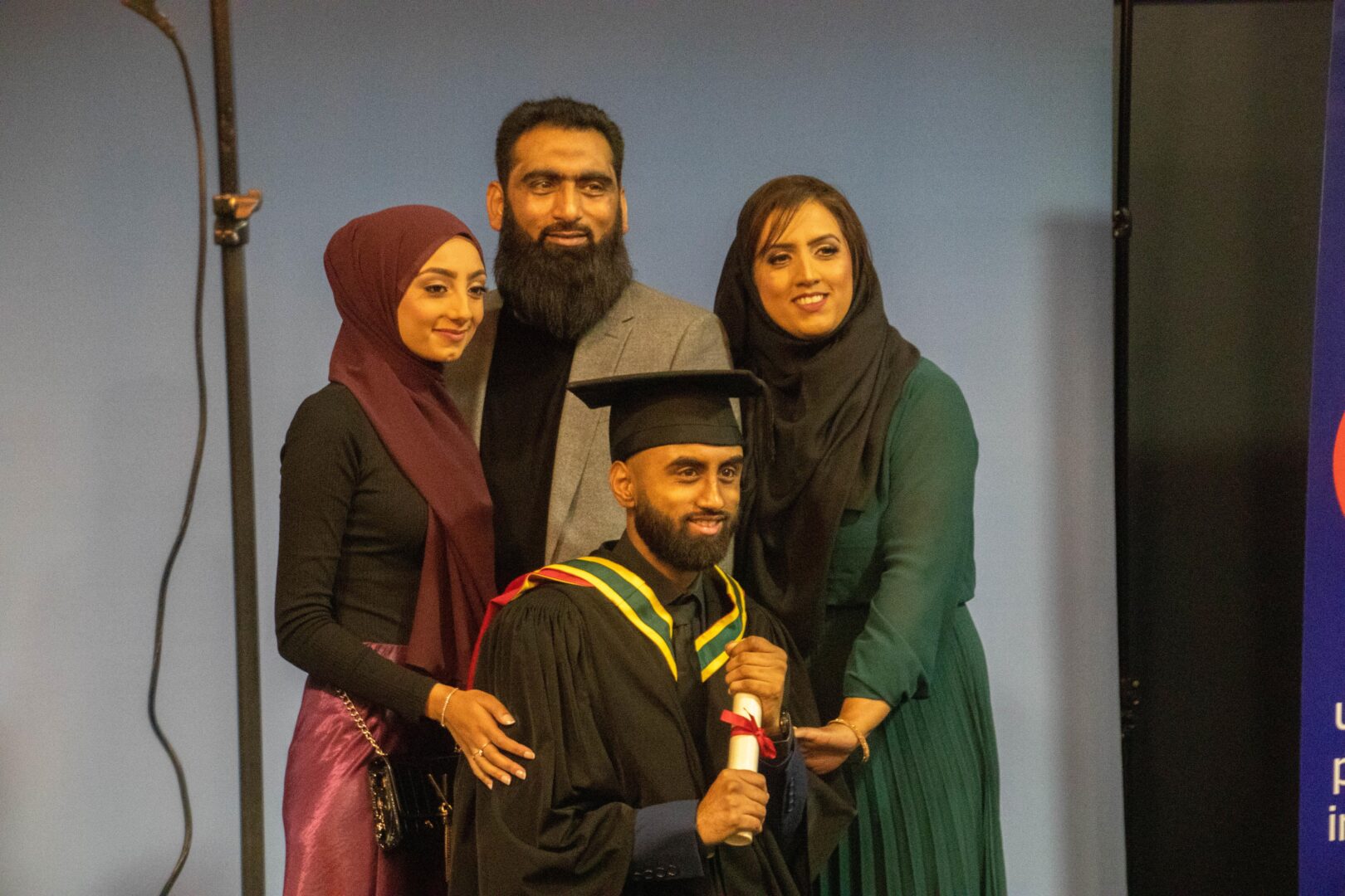 a family smiles and they get a professional photo taken