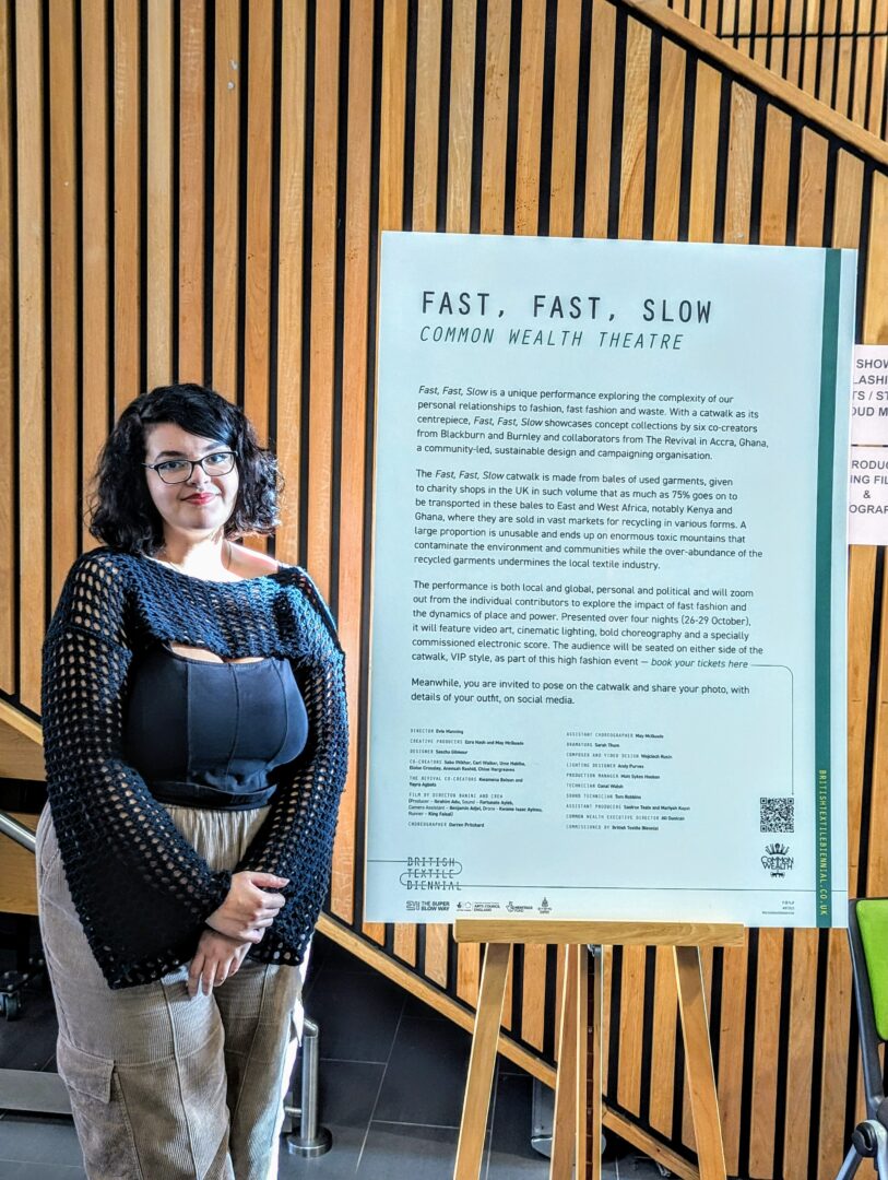 ellie dennis, a media makeup with special effects student, stood next to a board reading fast, fast, slow as well as the project being put on by bd is lit