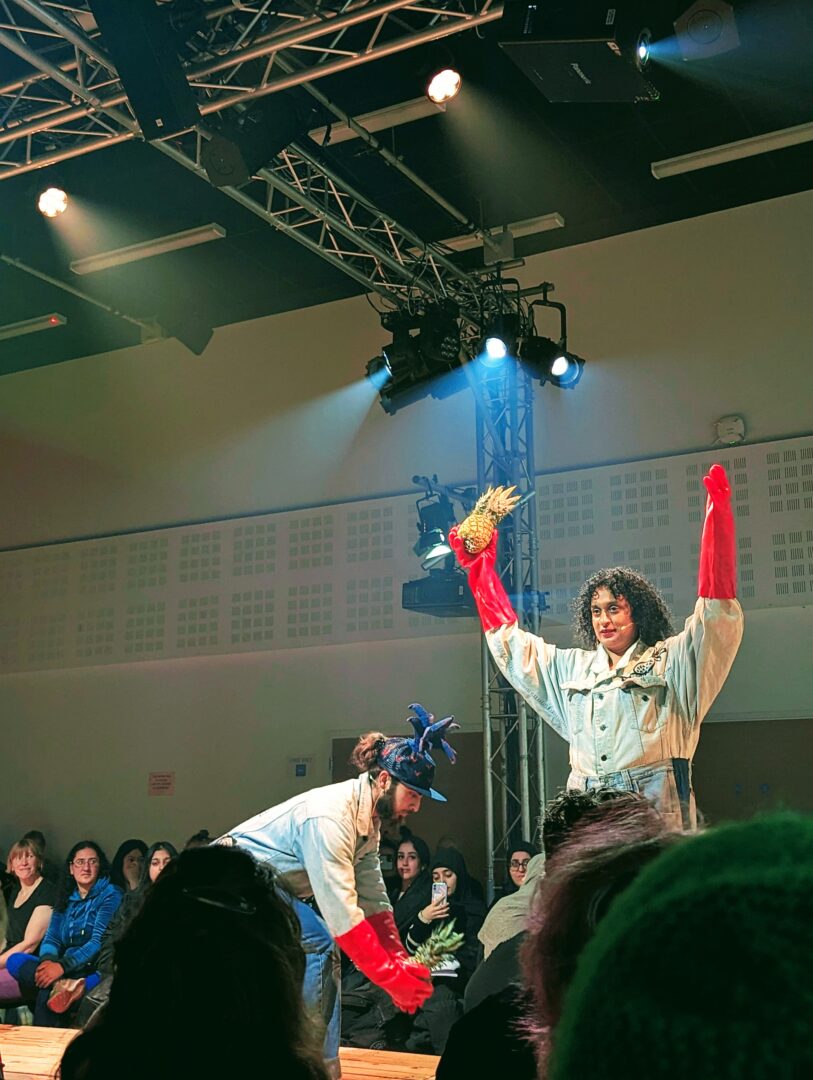 two performers on the catwalk wearing sustainable clothing