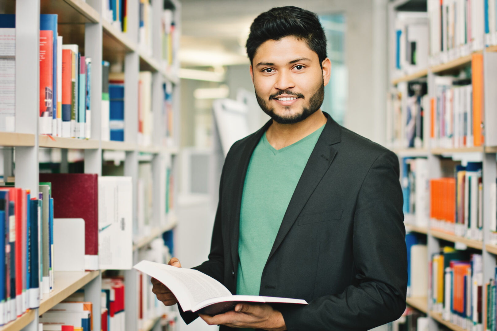 Indian male in library smiling
