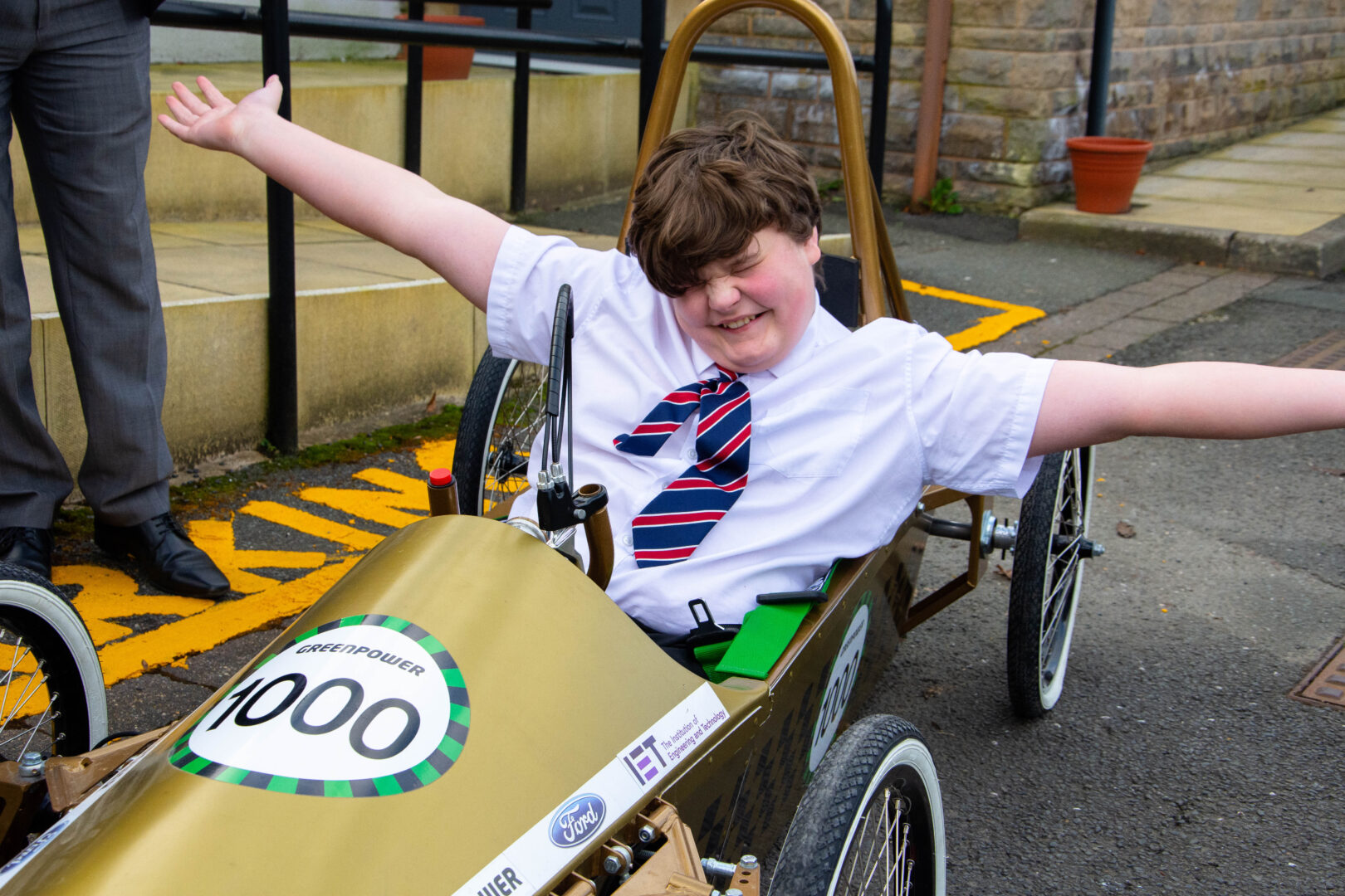 a school child sits in a greenpower car