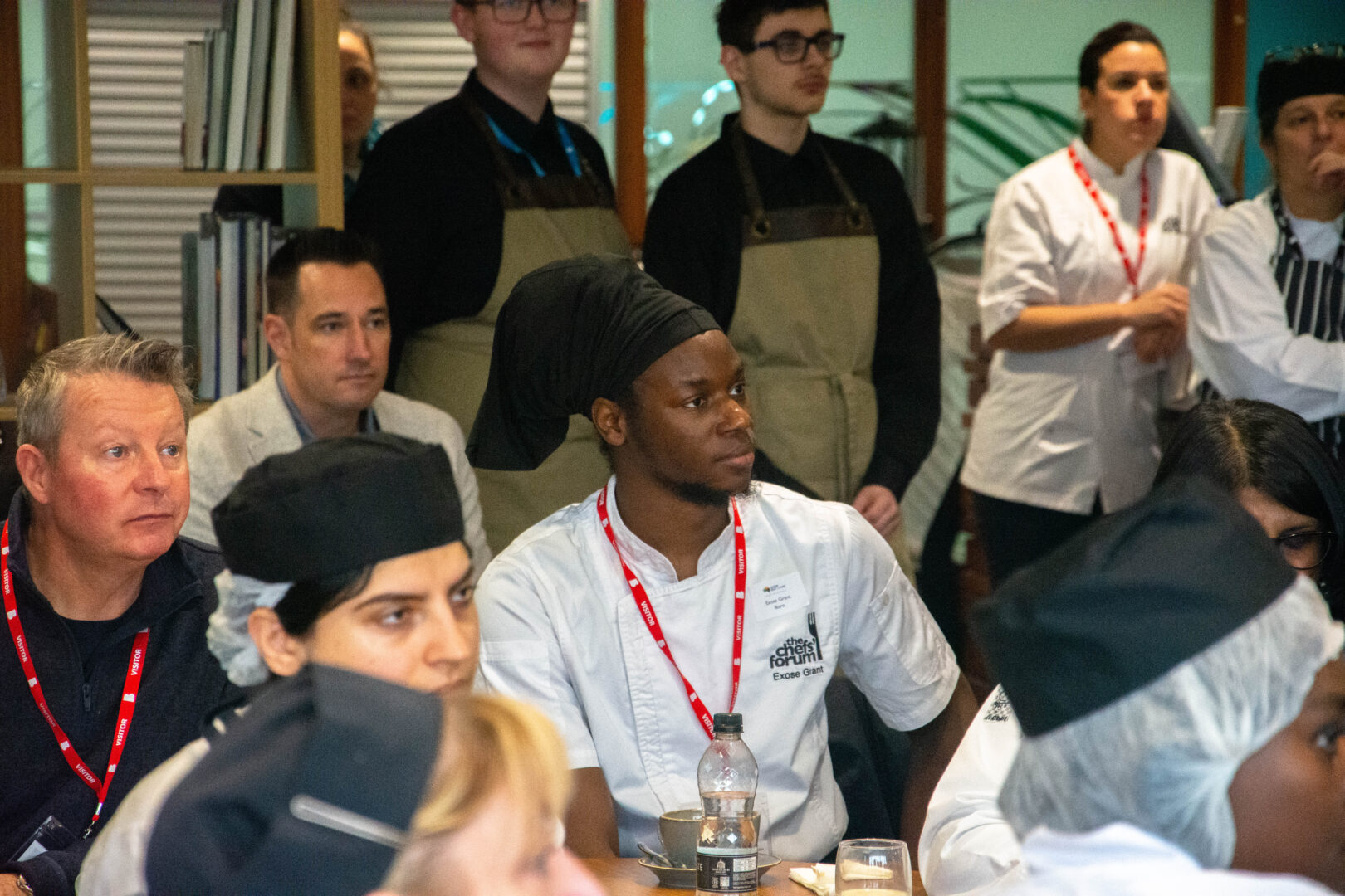 guest chef, xhose grant, sits among our students as they listen to a talk