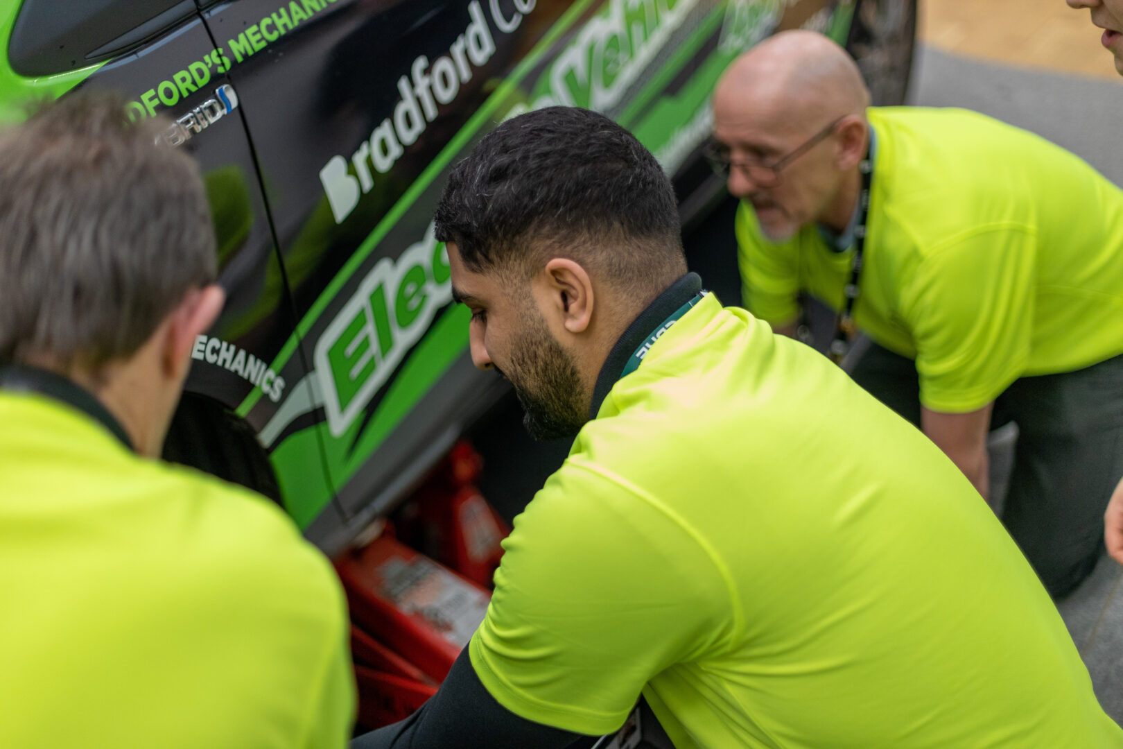 the cbre team change a wheel on an electric car