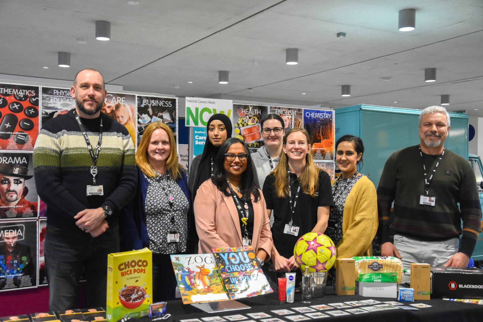 the bradford college careers team standing as a group next to a display about national careers week