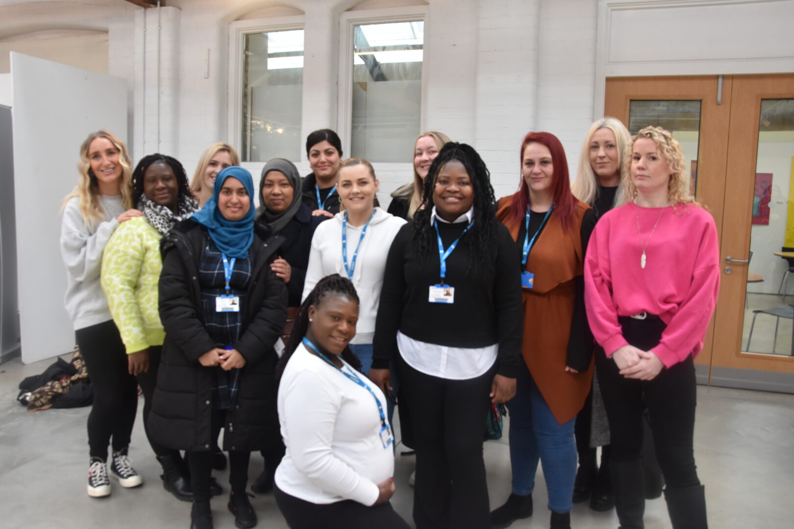 a group of students and employers standing together smiling