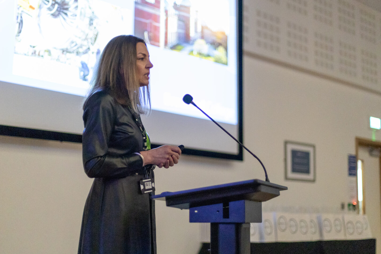 vice principal sarah cooper stands at a podium speaking to a lecture theatre full of students