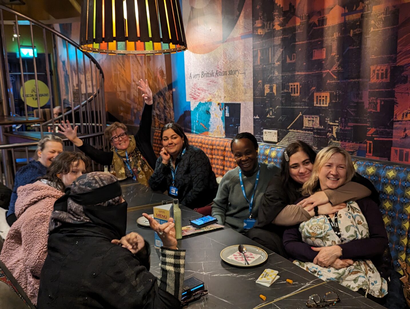a class of students and teachers sit at a table in the mylahore restaurant