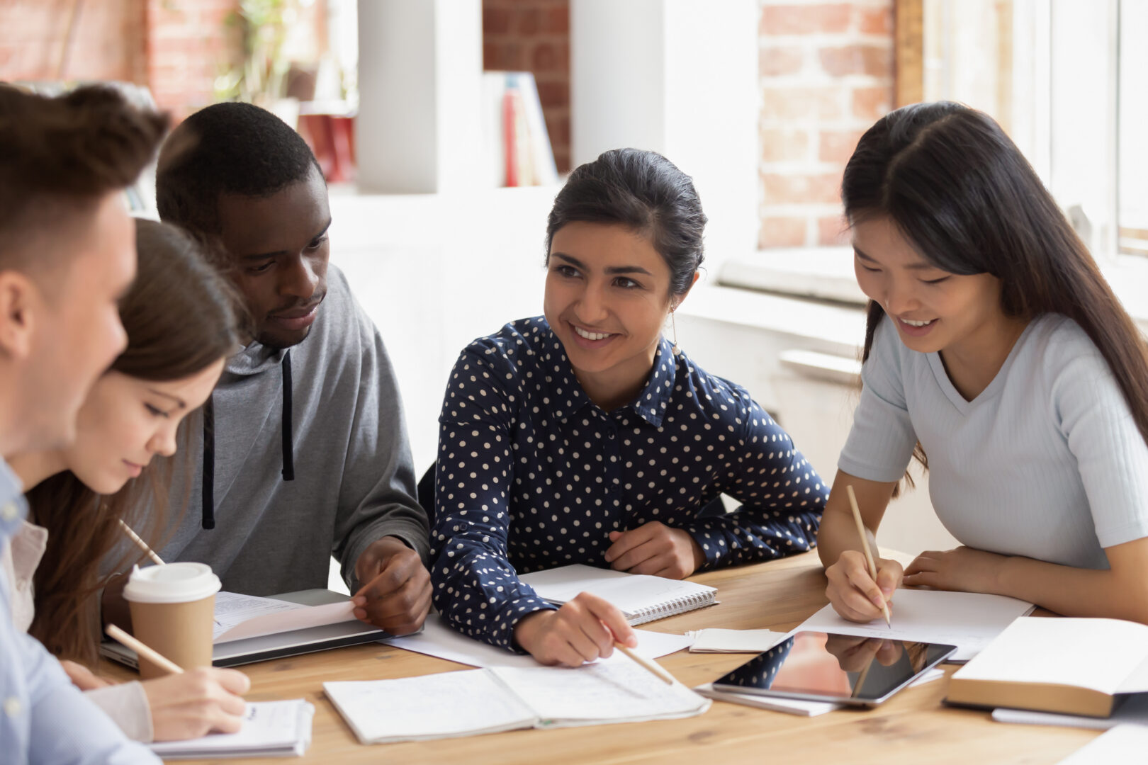 students sitting at a desk talking