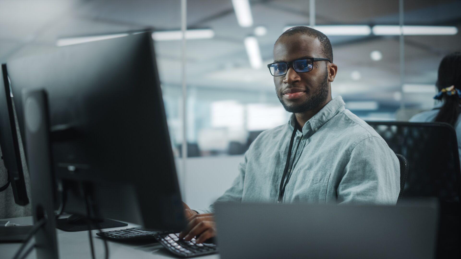 a student sits working at a desktop