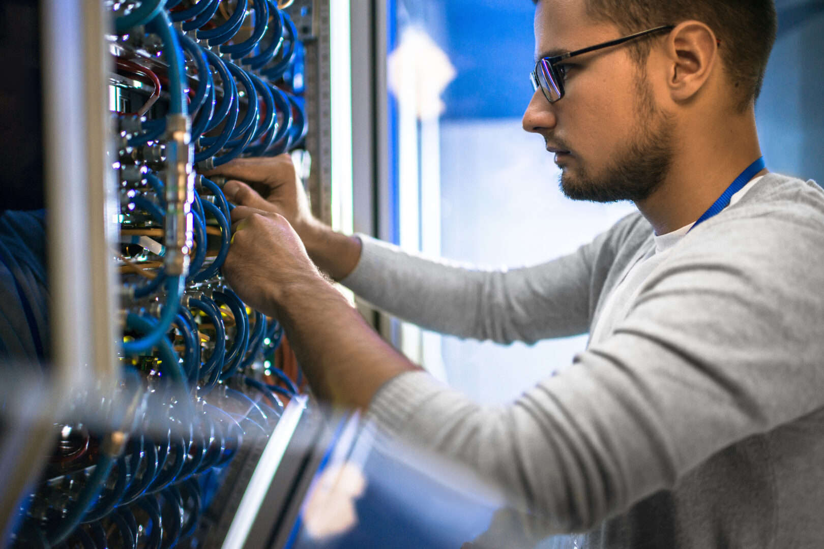 a student stands working on computer software