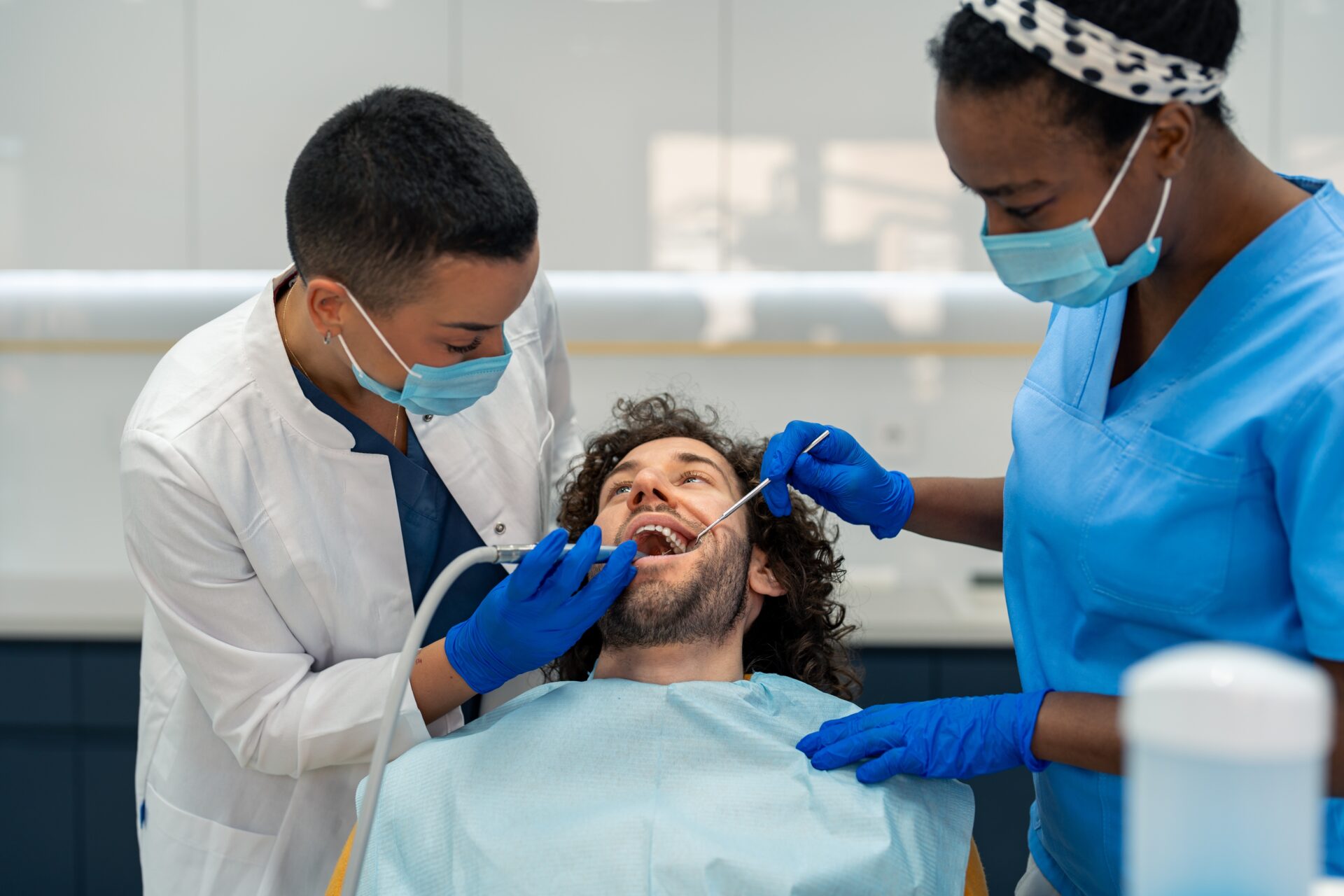 Dentist drilling a mans tooth
